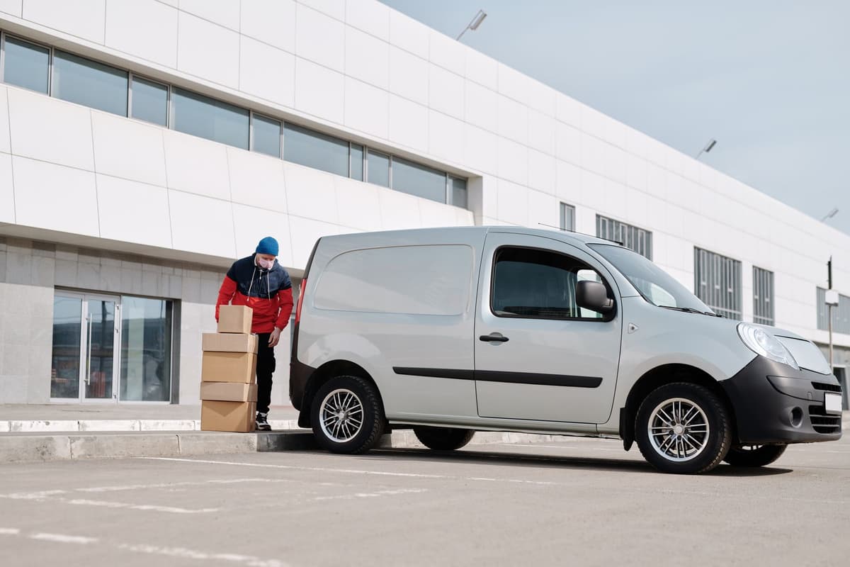 Courier unloading packages from a delivery van