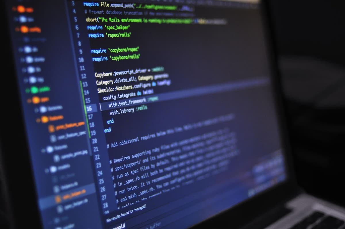 Laptop showing a code editor in a real workspace