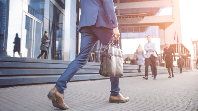 A professional commuting to work through a city business district